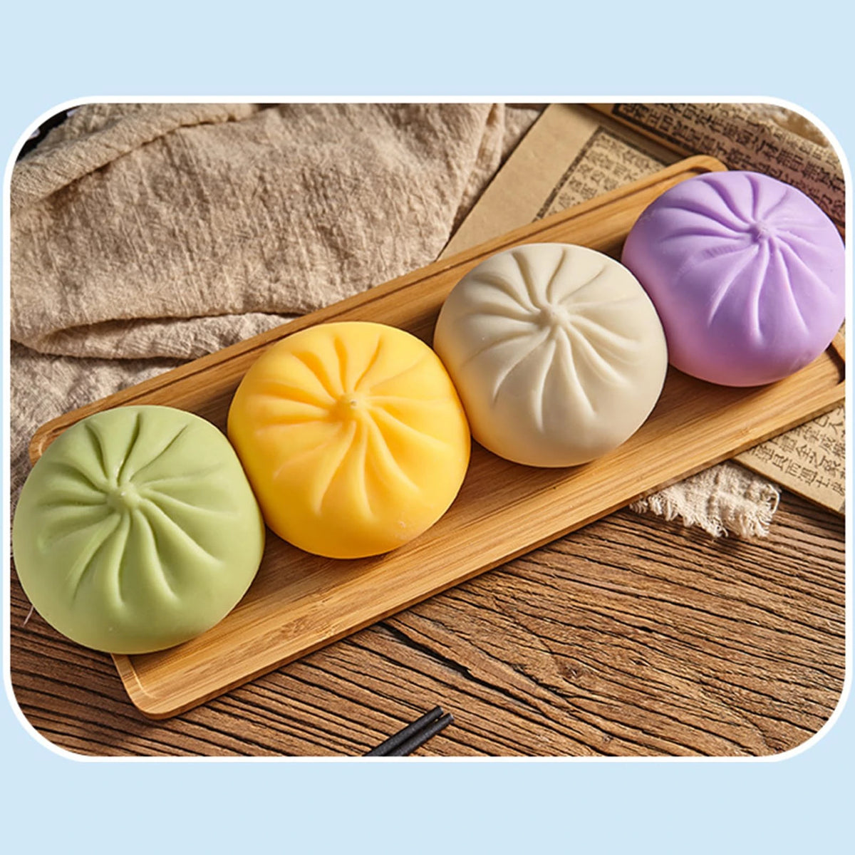 A collection of colorful, squishy bear-shaped stress relief fidget toys in pastel shades arranged on a wooden board.