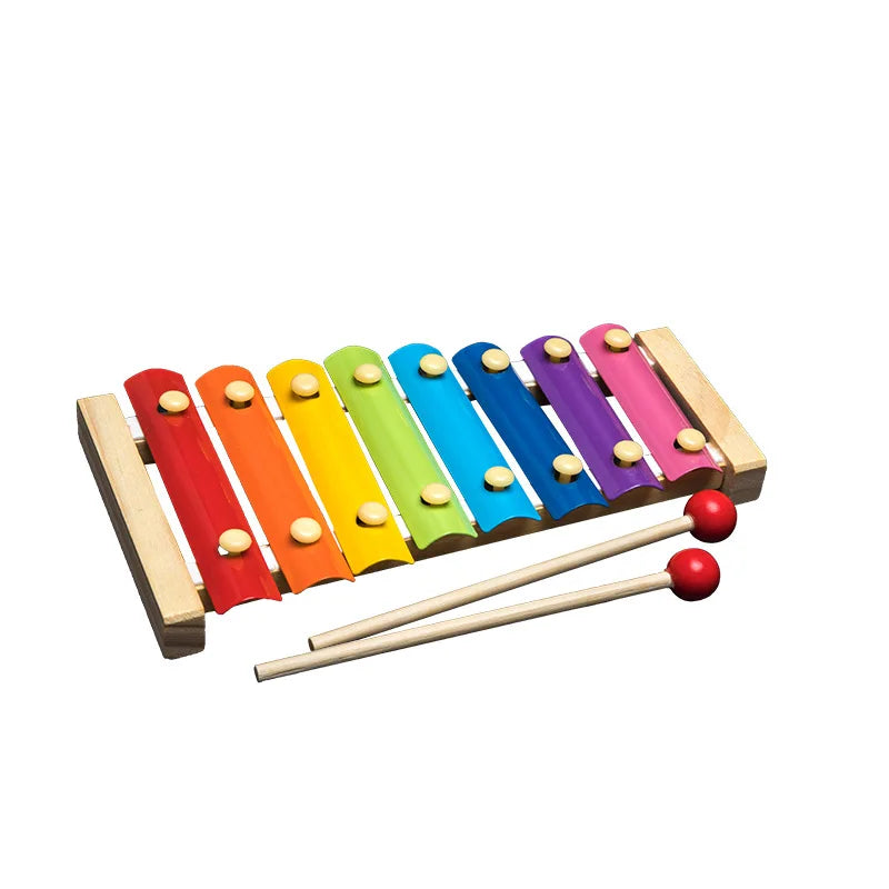 Wooden Montessori sensory blocks in various colors arranged on a wooden base with small red balls.