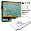 A box of a 1000-piece jigsaw puzzle featuring a light blue tree with white blossoms, including adhesive paper sheets.