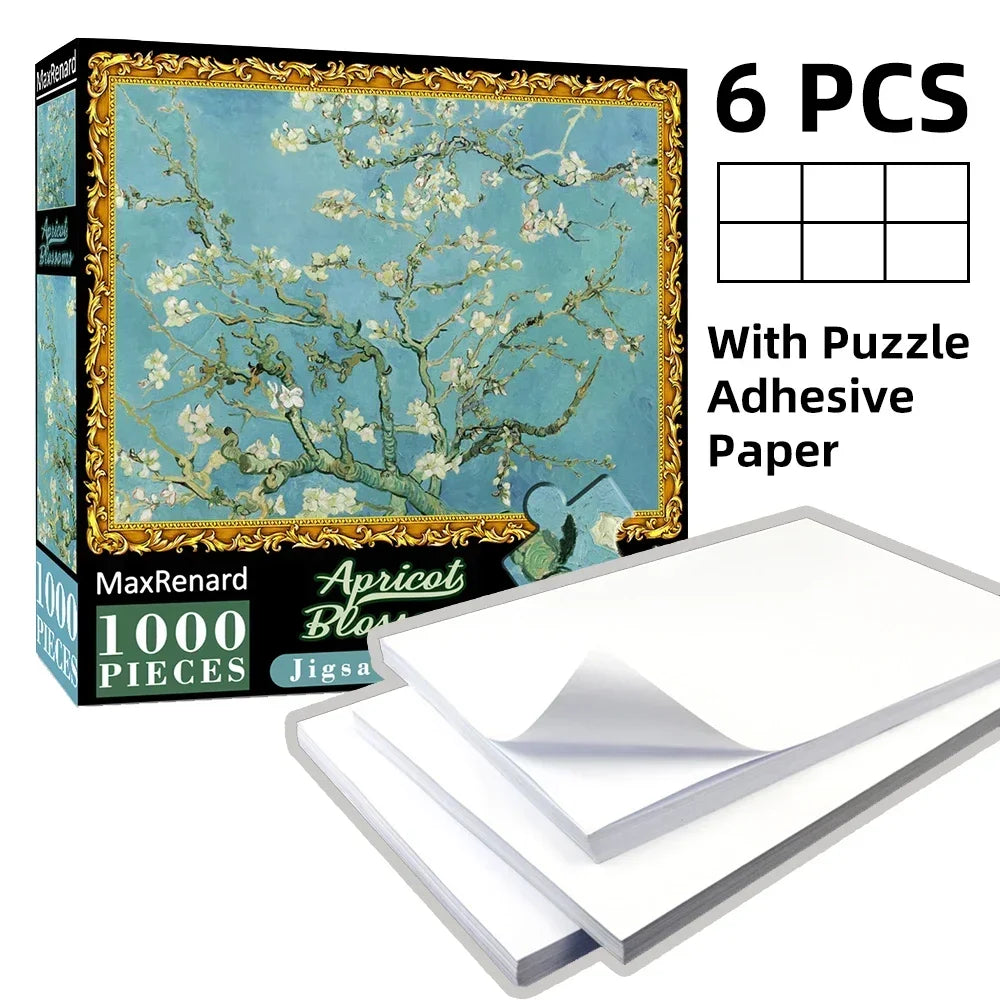 A box of a 1000-piece jigsaw puzzle featuring a light blue tree with white blossoms, including adhesive paper sheets.