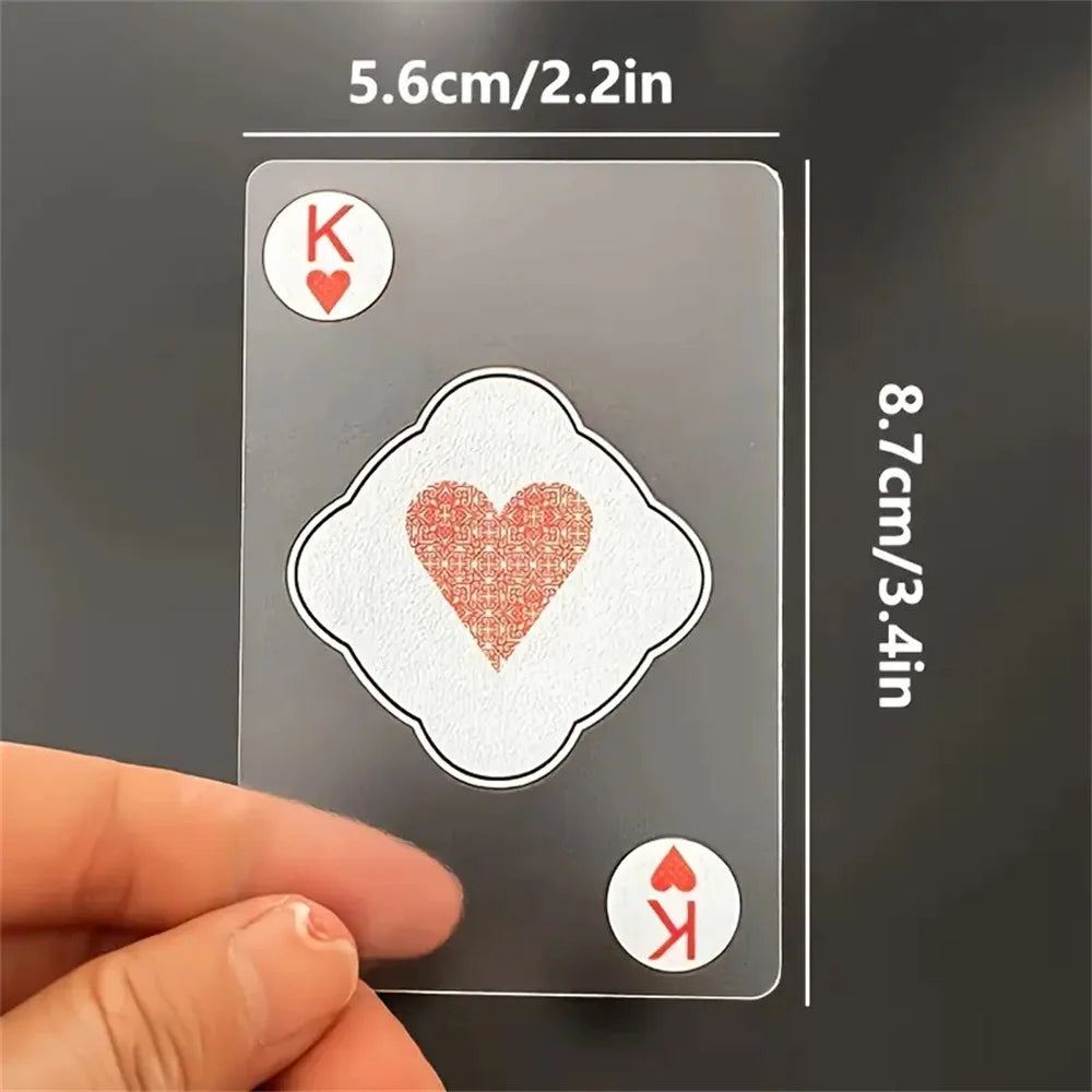A hand holds a transparent playing card with a King of Hearts symbol, showing its size and detail.