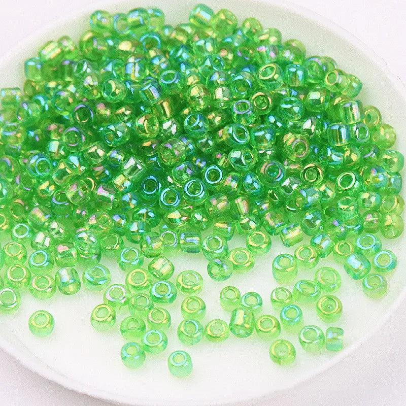 A pile of bright green glass rice beads for DIY jewelry and crafting.