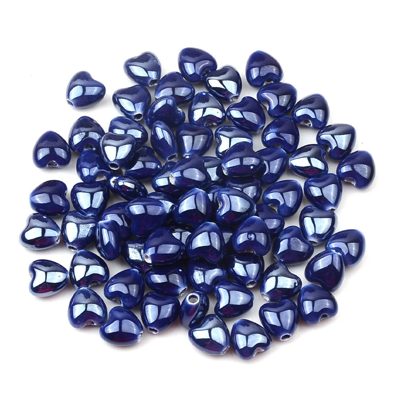 A pile of dark blue heart-shaped acrylic beads for jewelry making
