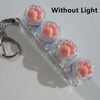 Clear acrylic keychain featuring four pink clicky key buttons for fidget use without light