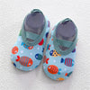 A pair of light blue baby barefoot water shoes decorated with colorful fish patterns