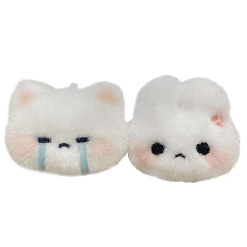 A pair of white plush rabbit keychain charms with blue tear accents.