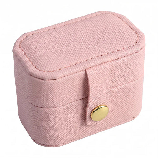 A pink portable leather jewelry storage box with a flap closure and gold-colored button.