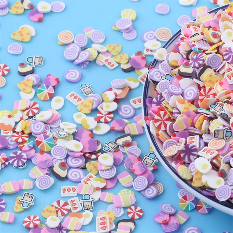 A close-up of mixed color polymer clay sprinkles scattered on a light blue surface.