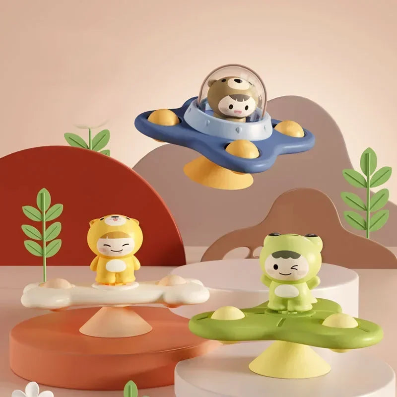 A set of three suction cup spinner bath toys for babies featuring a bear, a monkey, and a green animal.
