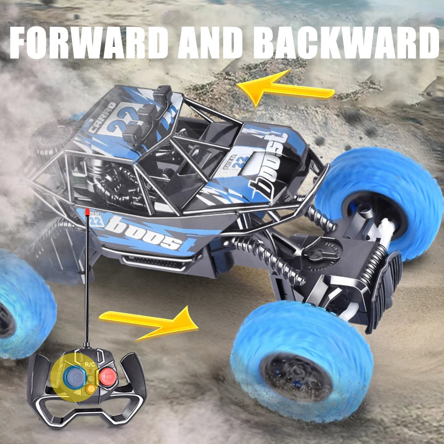 A black and blue off-road remote control car is shown with tires, a steering wheel, and flashing lights on a sandy surface.