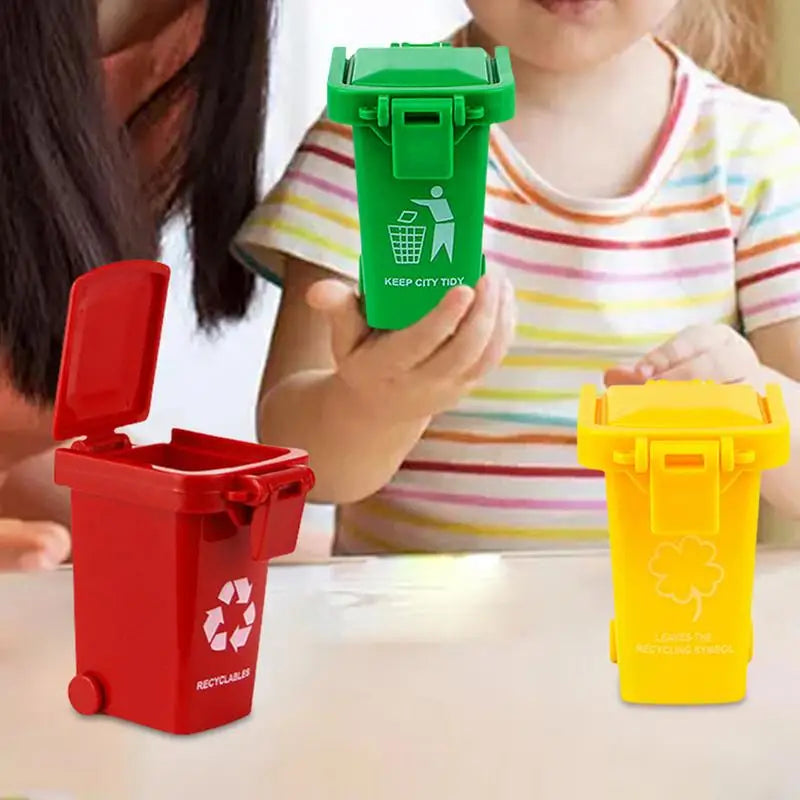 Two plastic recycling truck toys, one green and one yellow, are being held by a child.