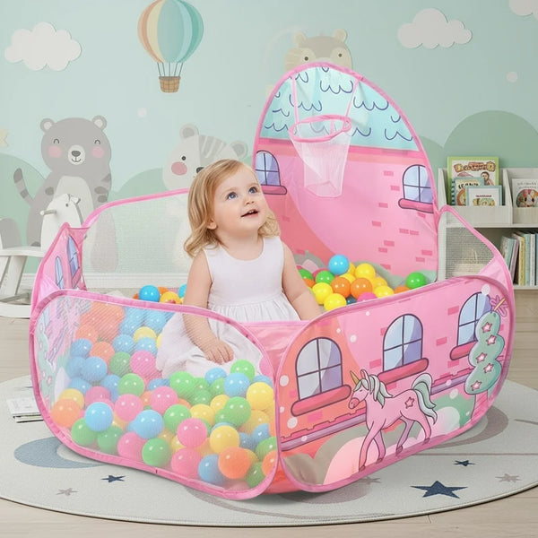 A pink foldable play tent for kids with colorful balls and a stuffed animal inside.