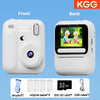 Front and back views of a white instant print camera showing the device, paper, and USB cable.