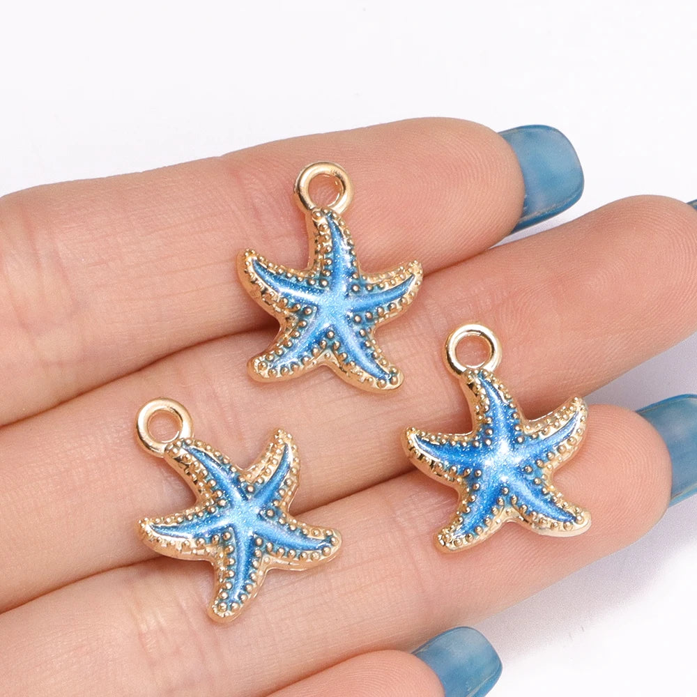 Gold-toned starfish enamel charms on a hand