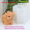 A light brown silicone mold of a Highland cow head used for making candles, soap, and crafts.