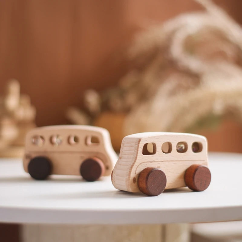 A wooden Montessori push cart toy featuring a handcrafted beech car and bus set on a white surface.