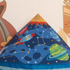 A blue rocket ship pop-up play tent with stars and planets is shown against a light background.