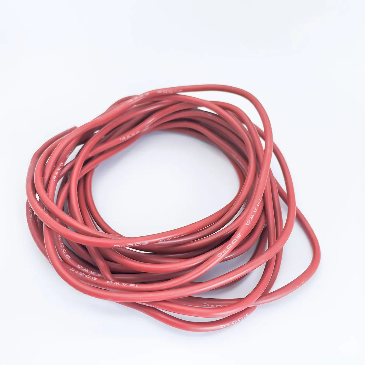 A coil of flexible silicone tinned copper wire in a reddish-pink color.