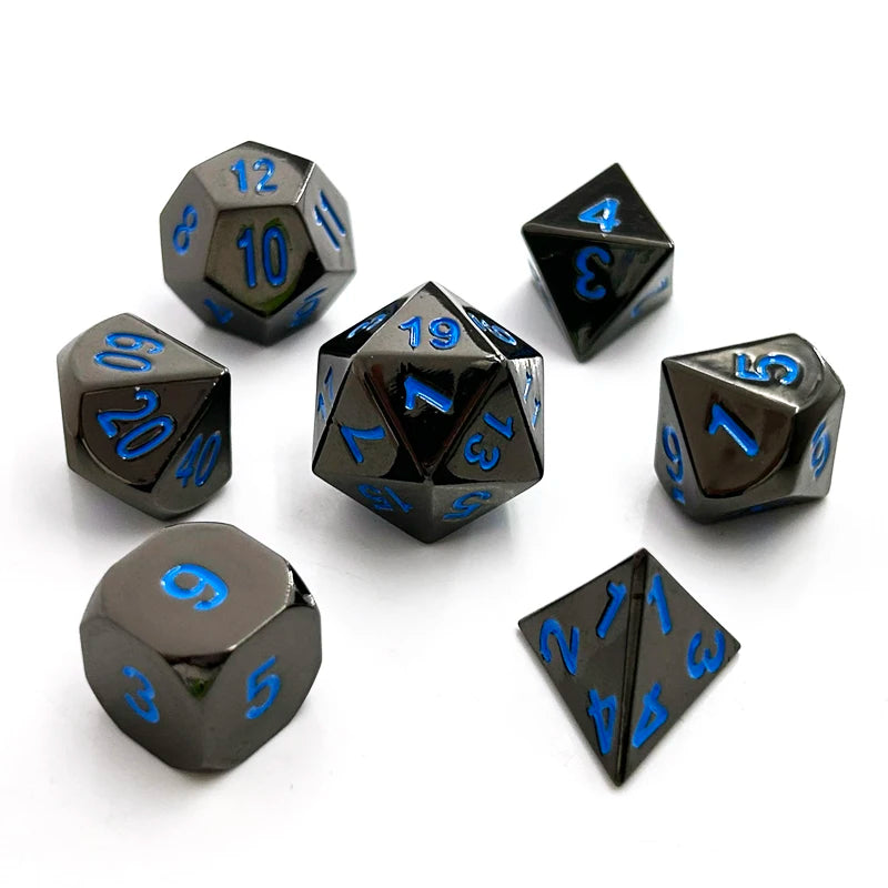A set of premium metal polyhedral dice with a dark finish and multicolor gold accents scattered on a white background.