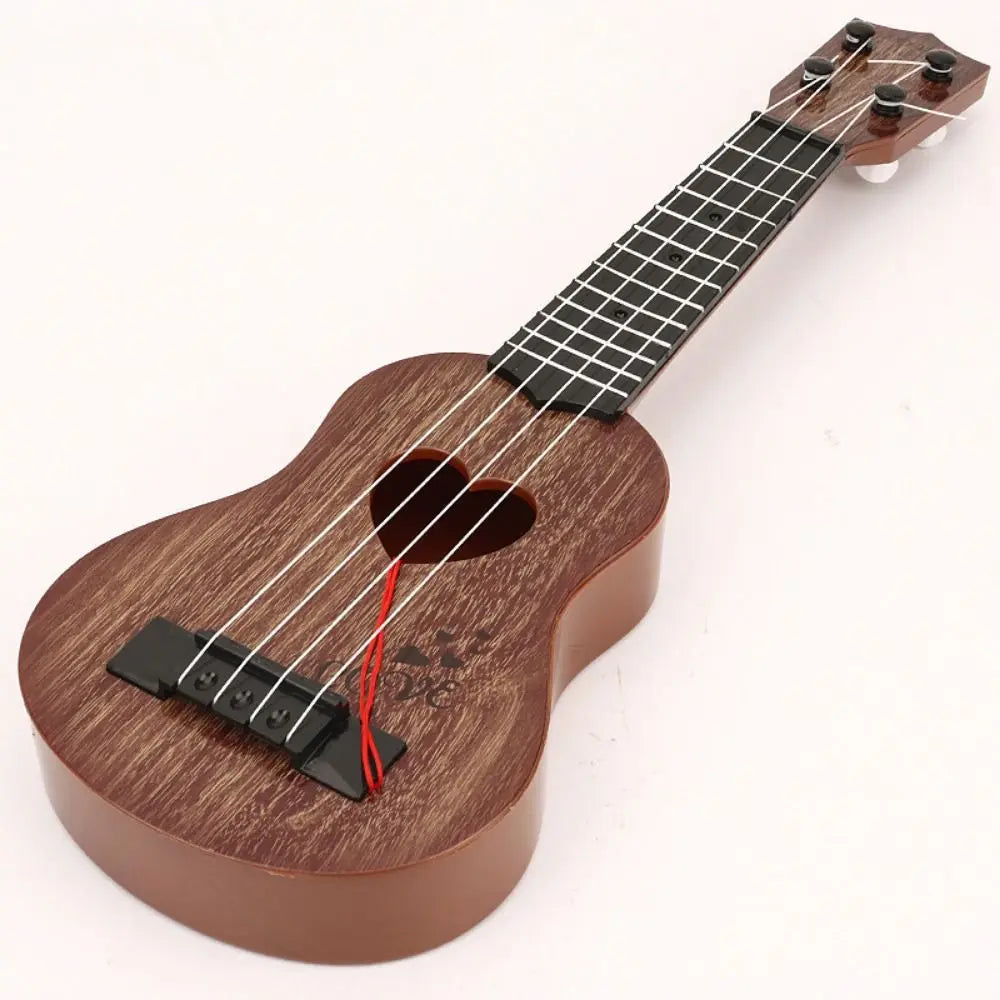 A wooden ukulele toy with adjustable tuning pegs and strings, shown from above.