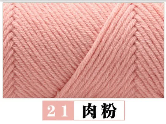 Close-up of pink milk cotton yarn showing a knitted texture and twisted strands.