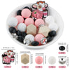 A variety of pink, white, and black cartoon animal silicone beads for DIY jewelry making are displayed in a white bowl.