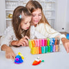 A young girl is modeling vibrant air dry clay in various colors, with a small purple clay figure and an orange clay animal ne