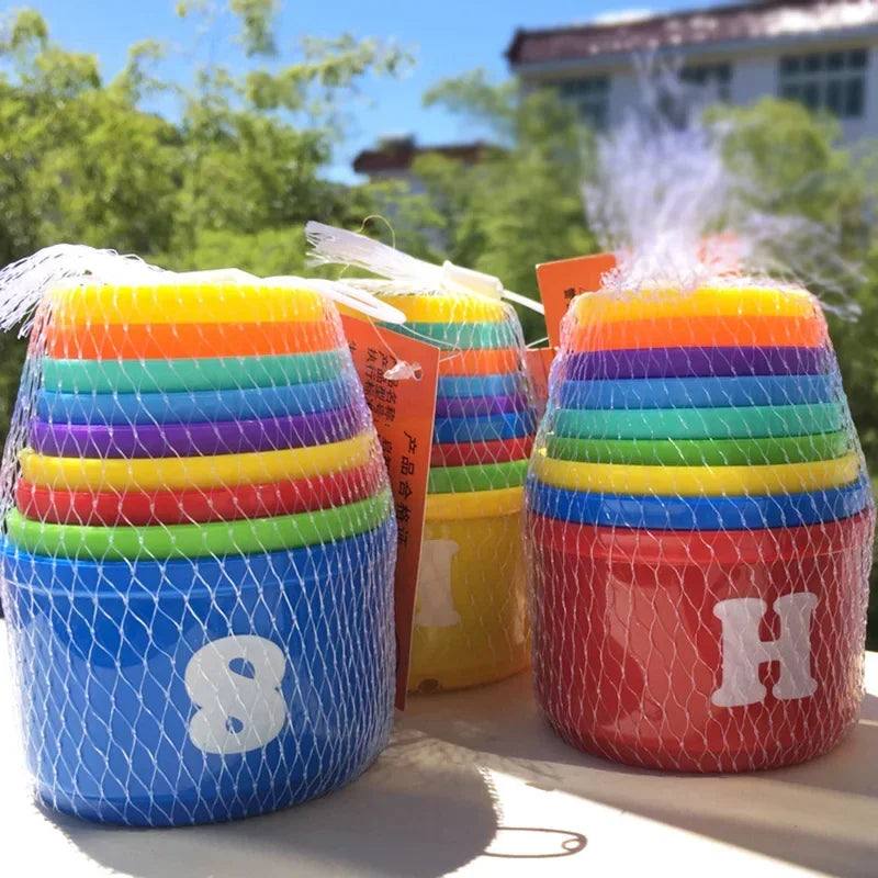 A set of colorful stacking cups with numbers and letters, including 8 and H, displayed outdoors.