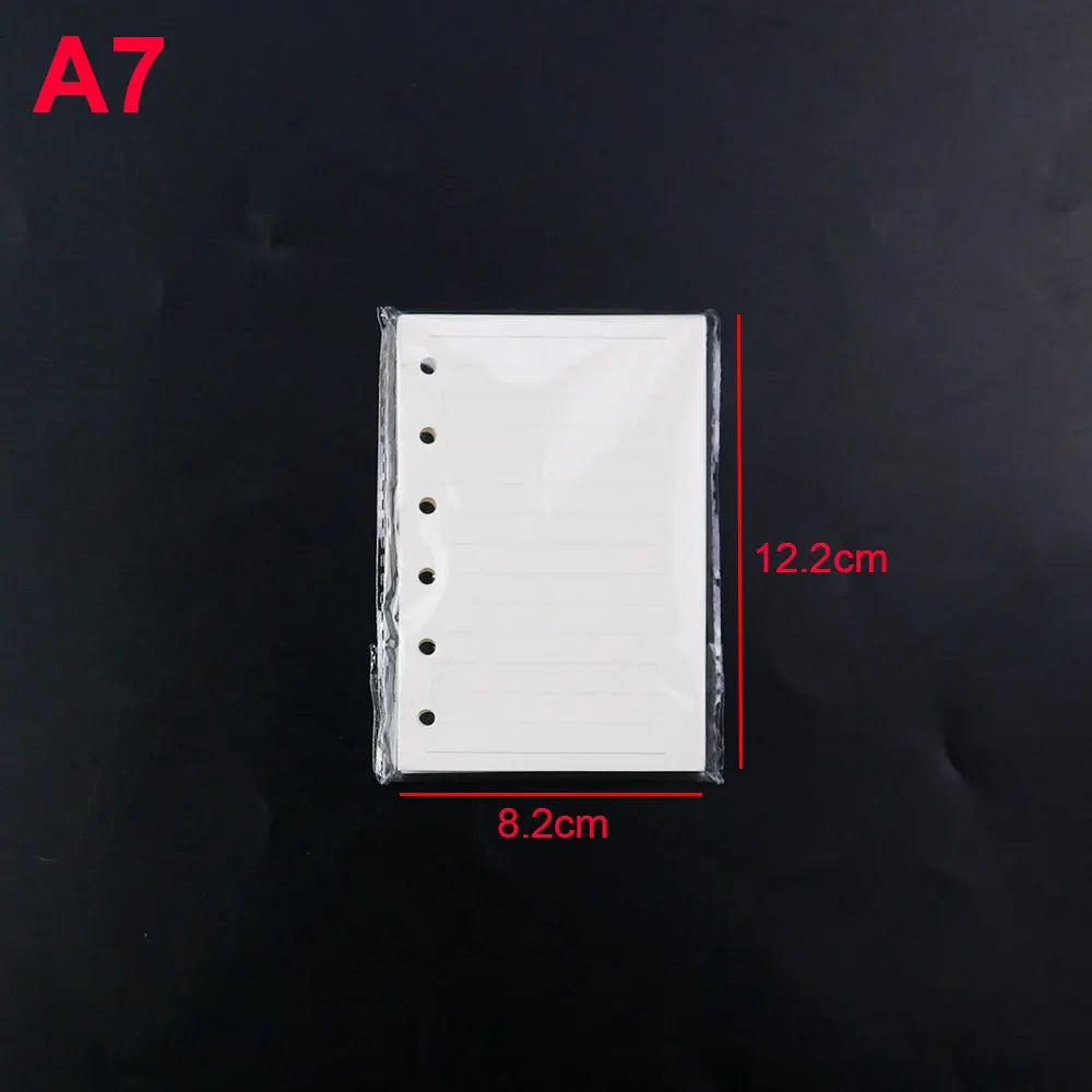 White silicone mold for an A7 notebook cover with punched holes, shown against a black background.
