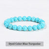 A bracelet made of dyed color blue turquoise beads on a white background.