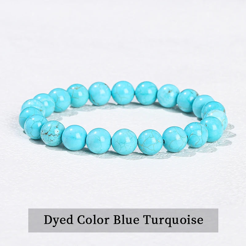 A bracelet made of dyed color blue turquoise beads on a white background.