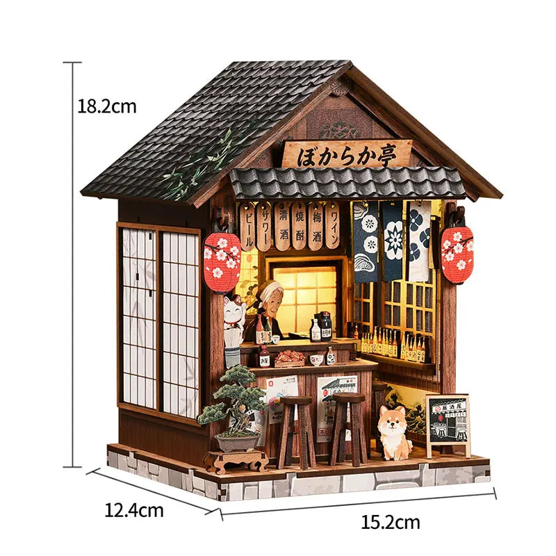 A miniature Japanese-style dollhouse kit featuring a wooden facade, shoji screens, and traditional furniture with warm lighti