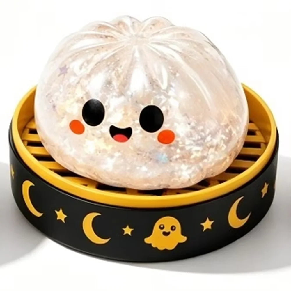 A translucent, spherical ghost dumpling squishy fidget toy with black accents resting in a yellow and black tray.