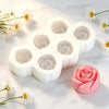 A white silicone mold set shaped like flowers is displayed on a marble surface next to a pink rose flower.