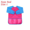 A pink and blue waterproof kids art and baking apron with long sleeves
