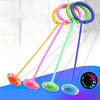 A set of colorful, foldable jump rings or hoops in yellow, pink, green, and blue against a blue background.