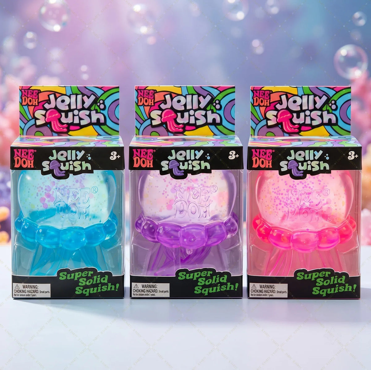 Three boxes of Nee Doh Jelly Squish toys in various colors including blue, purple, and pink.