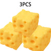 Three yellow cheese squishy fidget toys are shown in a close-up view.