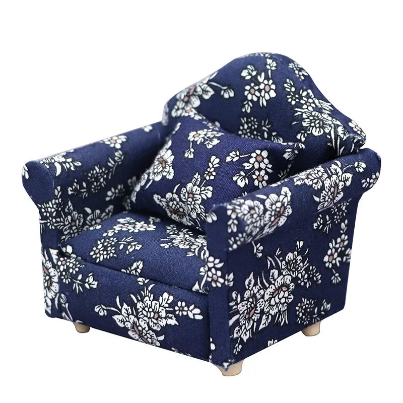A navy blue floral patterned mini sofa and pillow set for a dollhouse