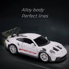White Porsche 911 GT3 RS diecast model car with perfect lines displayed against a dark background.