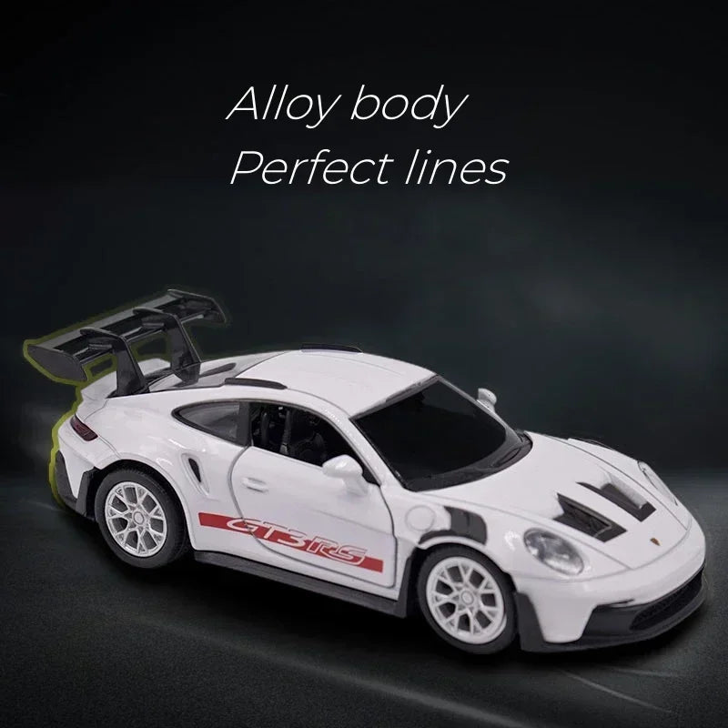 White Porsche 911 GT3 RS diecast model car with perfect lines displayed against a dark background.