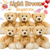 A collection of light brown teddy bears, including a large plush bear and several smaller ones.