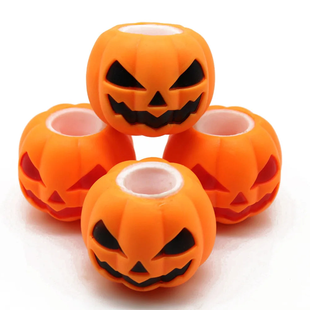An orange Halloween pumpkin squishy fidget toy with a carved face design.