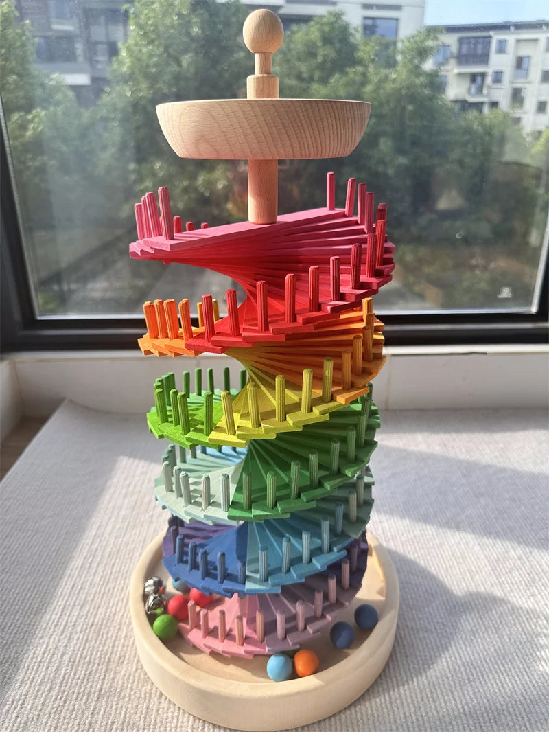 A colorful sensory music tree with a marble run structure made of stacked, brightly colored wooden pieces.