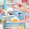 A hand is placing a mini food capsule into a white dish inside a miniature fridge playset.