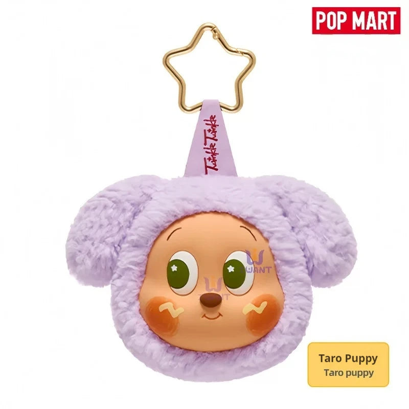 A cute purple bunny plush toy with large eyes and a gold hanger, used as an earbud case cover.