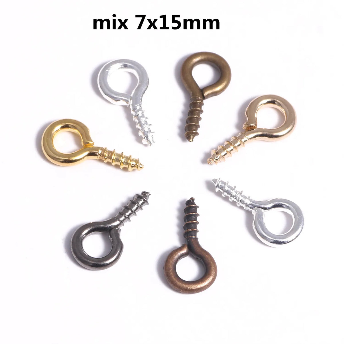 A collection of mini eye pins with screw threads in various metals, including silver, gold, and bronze tones.