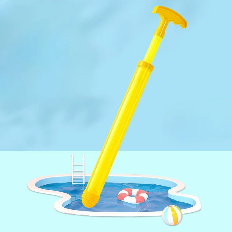 A yellow water spray toy is shown dipping into a shallow pool with other colorful toys.
