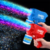 A hand holds a red bubble gun and a blue bubble gun, with colorful soap bubbles spraying in the background.
