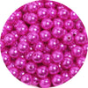 A pile of pink and purple imitation pearl beads for DIY jewelry making